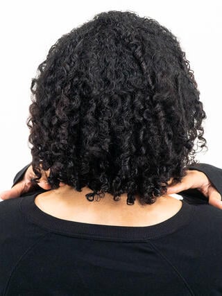 After photo: rear view of woman with short black hair with even color throughout.